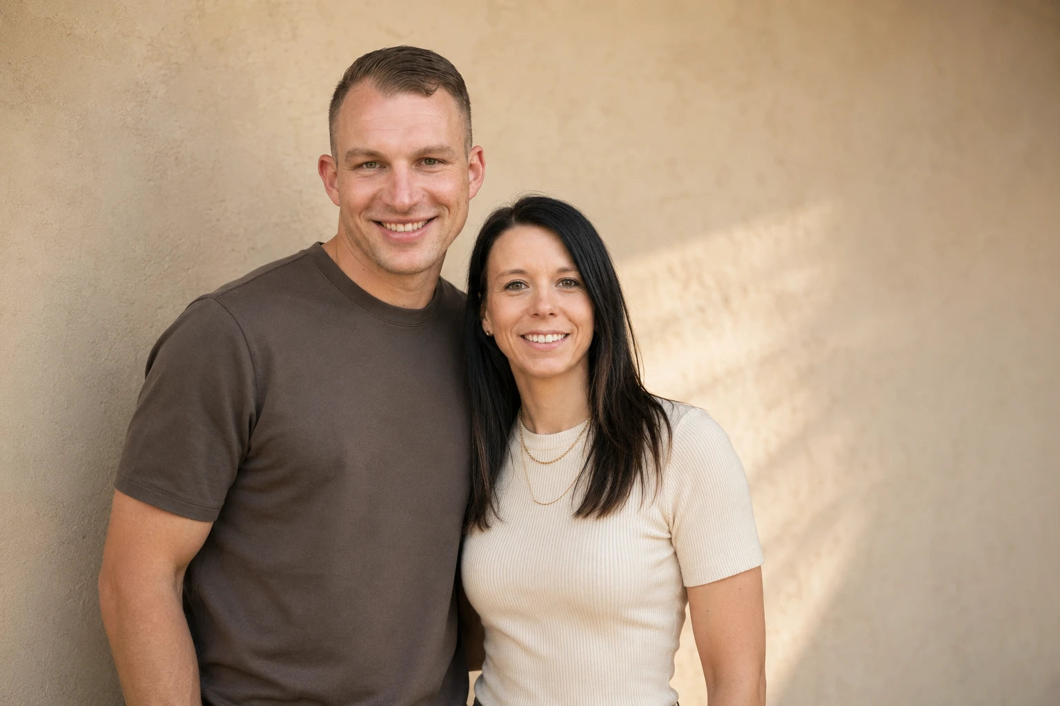 Melanie und Sebastian von LaserArt Germany vor einer hellen Wand im Sonnenlicht