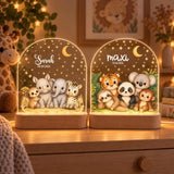 Two safari night lights with Sarah and maxi, glowing in front of giraffe on a chest of drawers
