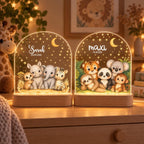 Two safari night lights with Sarah and maxi, glowing in front of giraffe on a chest of drawers